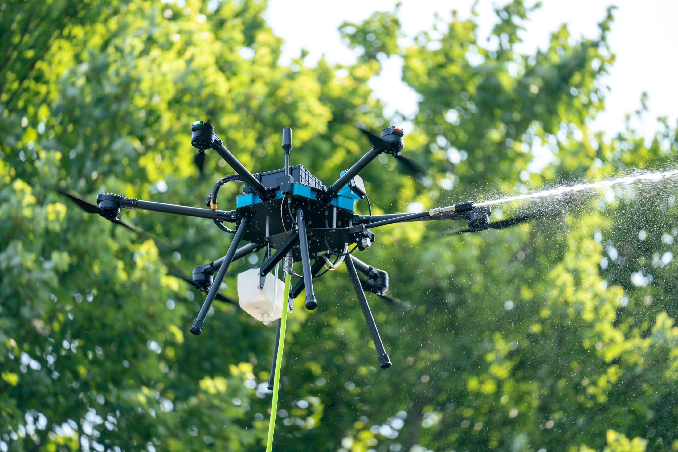Close-up of an octocopter cleaning drone spraying water