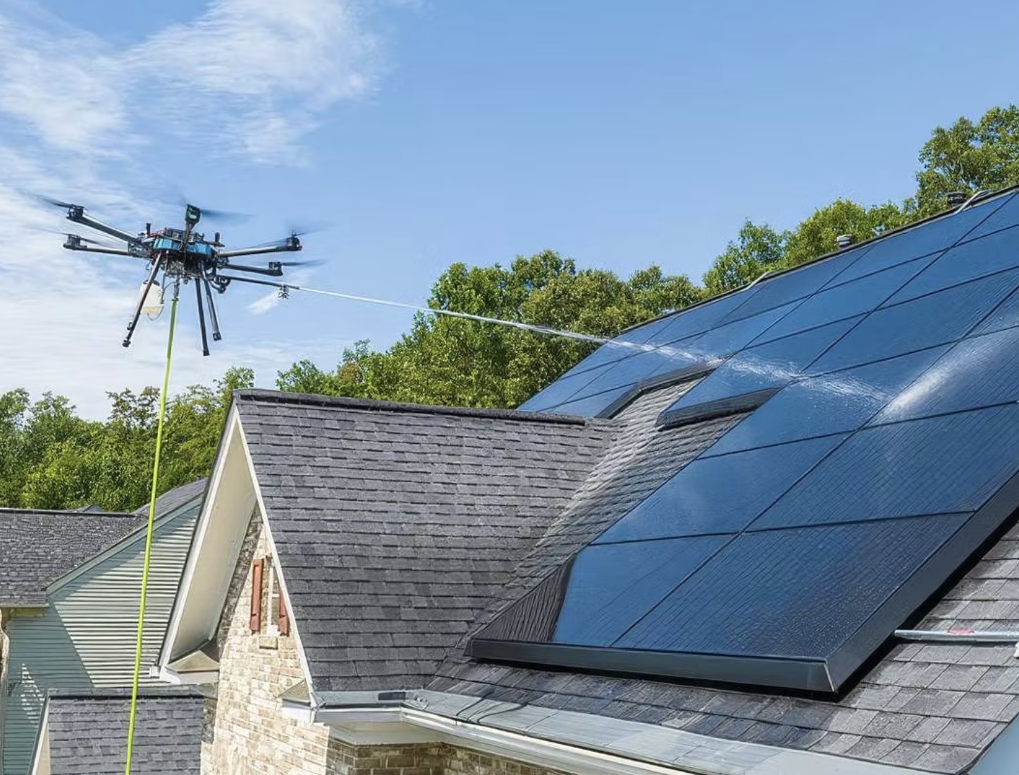 Drone washing rooftop solar on a home