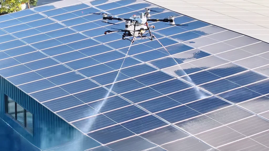 Drone cleaning a commercial rooftop solar array